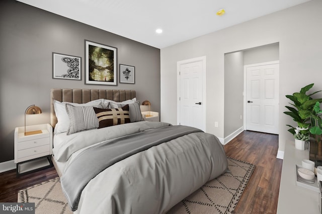 bedroom with dark hardwood / wood-style floors