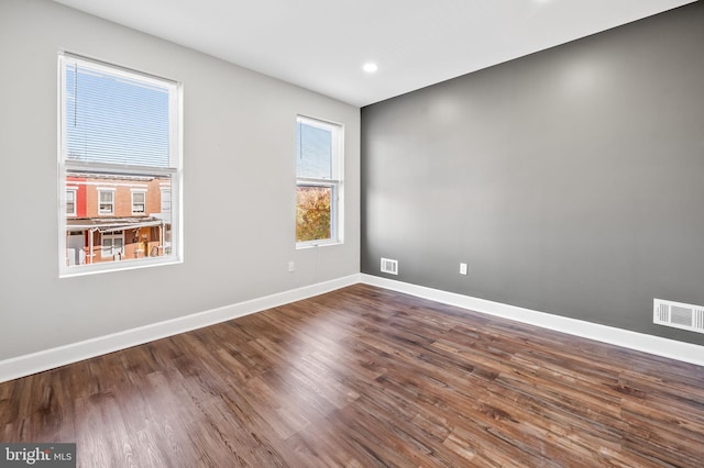 empty room featuring dark hardwood / wood-style flooring