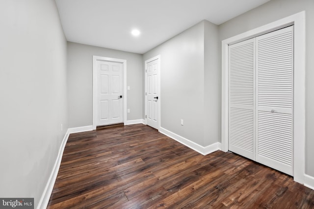 unfurnished bedroom with dark hardwood / wood-style floors