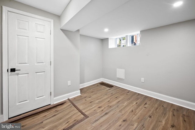 basement with light hardwood / wood-style floors