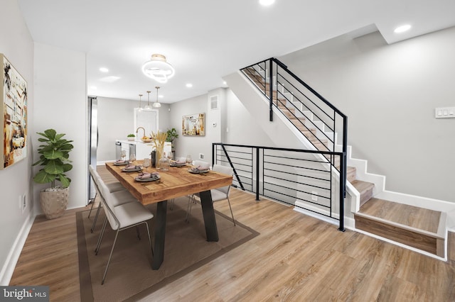 dining space with light wood-type flooring and sink