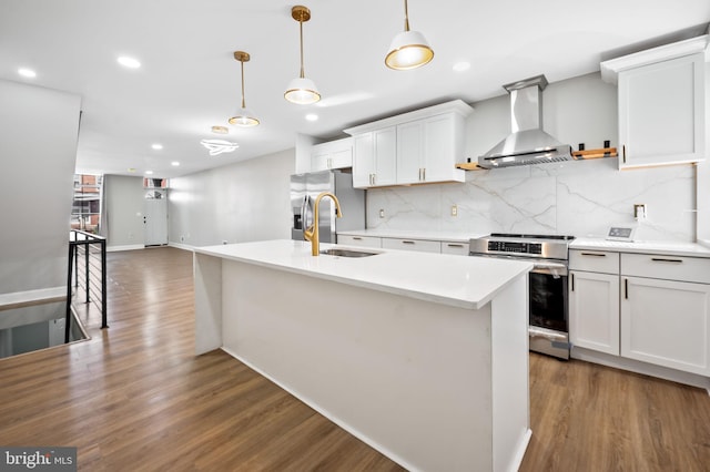 kitchen featuring stainless steel appliances, dark hardwood / wood-style floors, hanging light fixtures, white cabinets, and wall chimney range hood