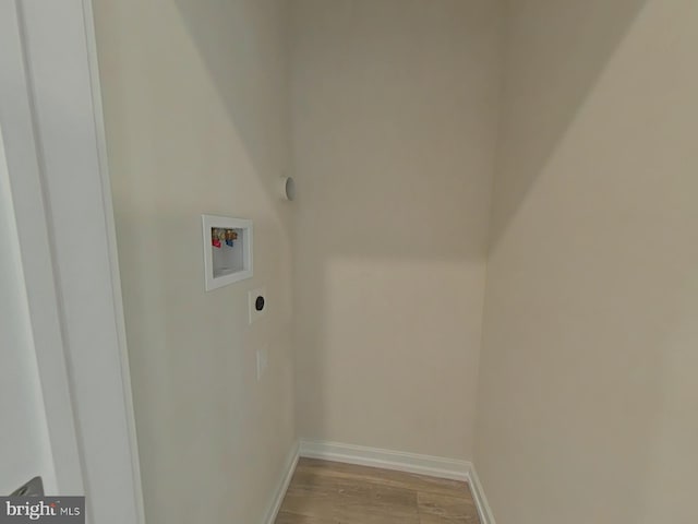 washroom featuring electric dryer hookup, hookup for a washing machine, and light hardwood / wood-style flooring