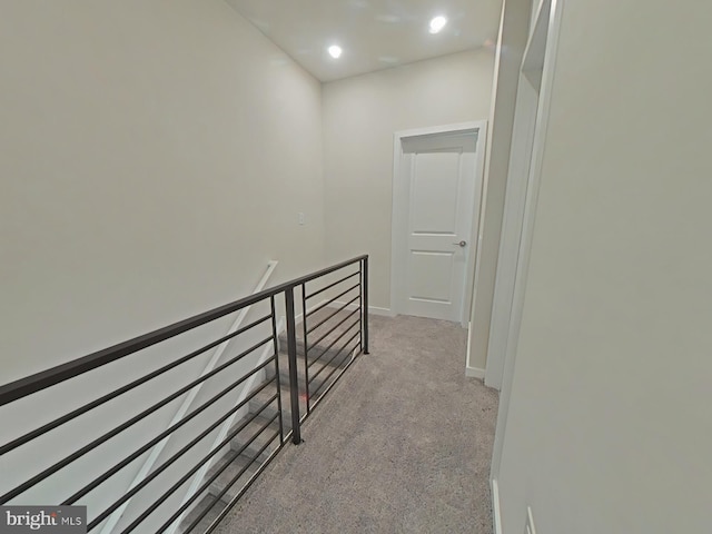 hallway with light colored carpet