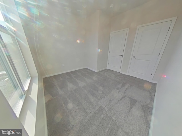 unfurnished room with carpet flooring