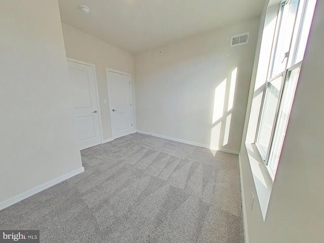 carpeted spare room with plenty of natural light