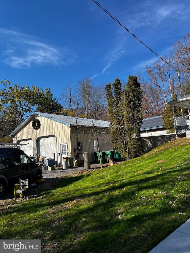 exterior space with an outbuilding, a yard, and a garage