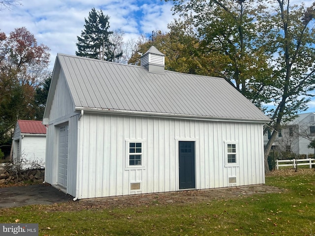 view of outbuilding with a lawn