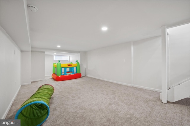 recreation room with light carpet