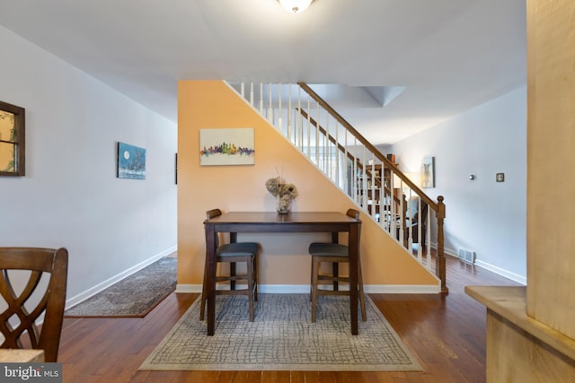 staircase with hardwood / wood-style flooring