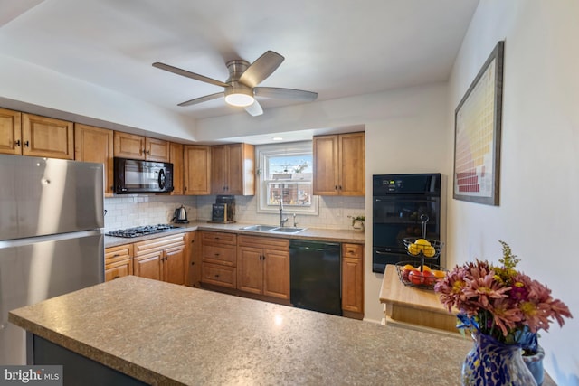 kitchen with black appliances, backsplash, sink, and ceiling fan