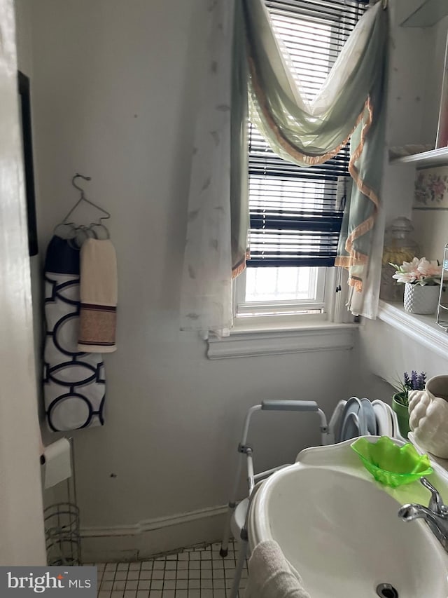 bathroom with sink and tile patterned flooring