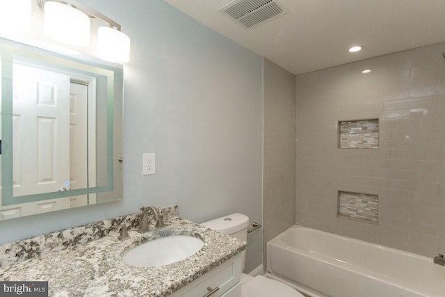 full bathroom with toilet, tiled shower / bath combo, and vanity