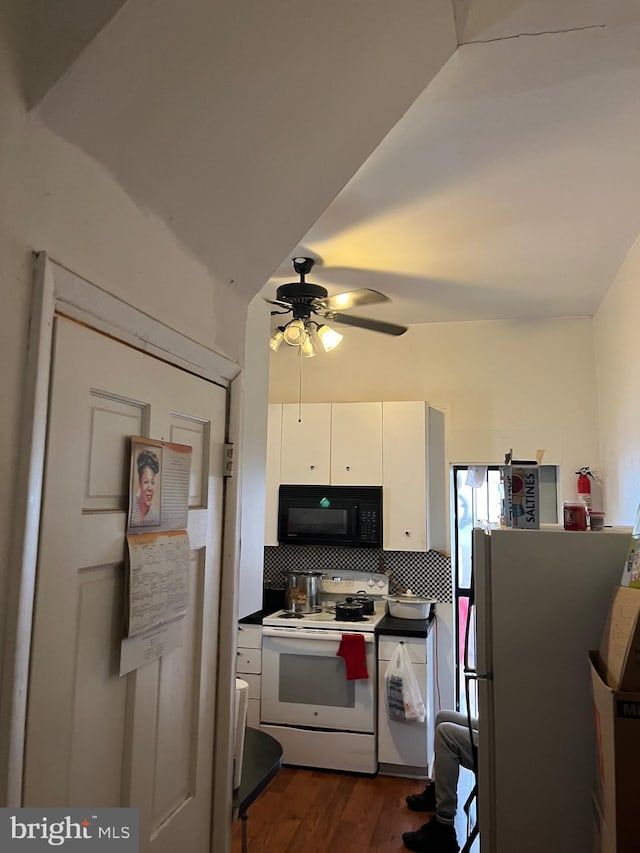 kitchen featuring dark hardwood / wood-style flooring, white cabinets, tasteful backsplash, ceiling fan, and white appliances