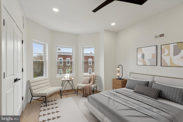 bedroom with ceiling fan and light hardwood / wood-style flooring