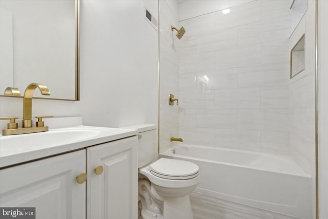 full bathroom with toilet, hardwood / wood-style floors, vanity, and tiled shower / bath