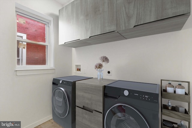 washroom with cabinets and washer / dryer