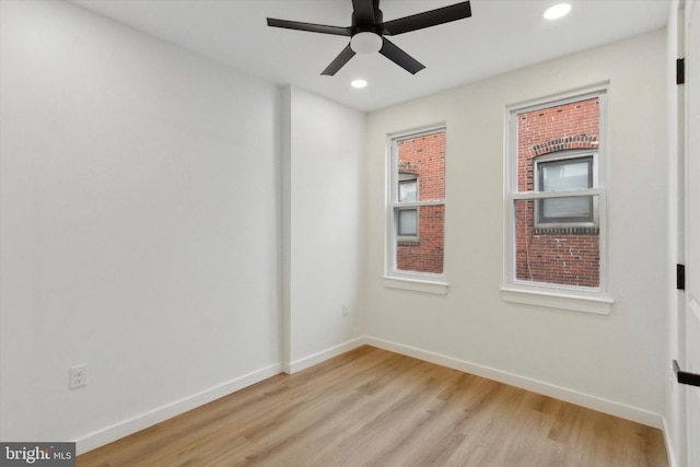 empty room with light hardwood / wood-style flooring and ceiling fan