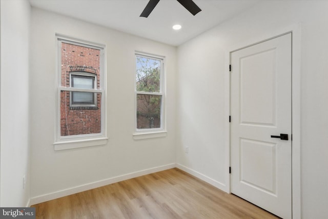 spare room featuring ceiling fan and light hardwood / wood-style flooring