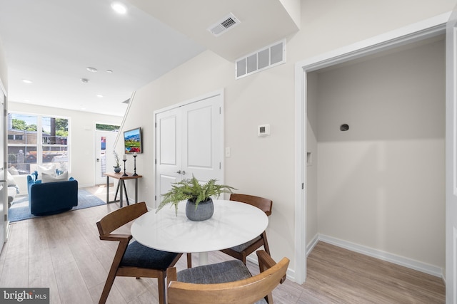 dining space with light hardwood / wood-style flooring