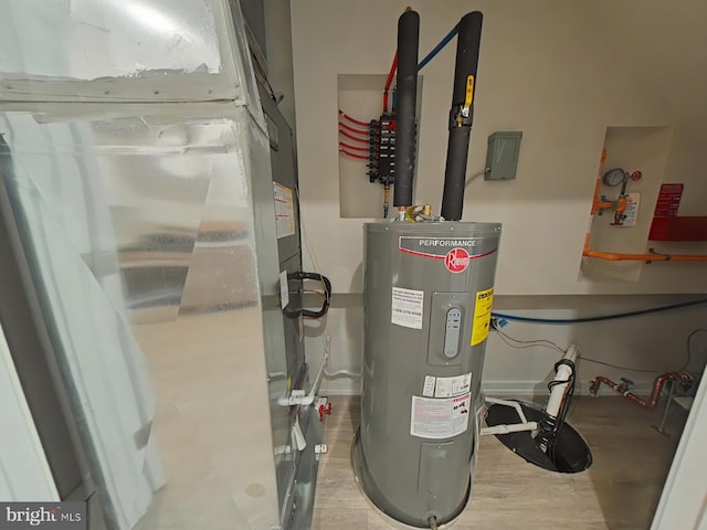 utility room with electric water heater and heating unit