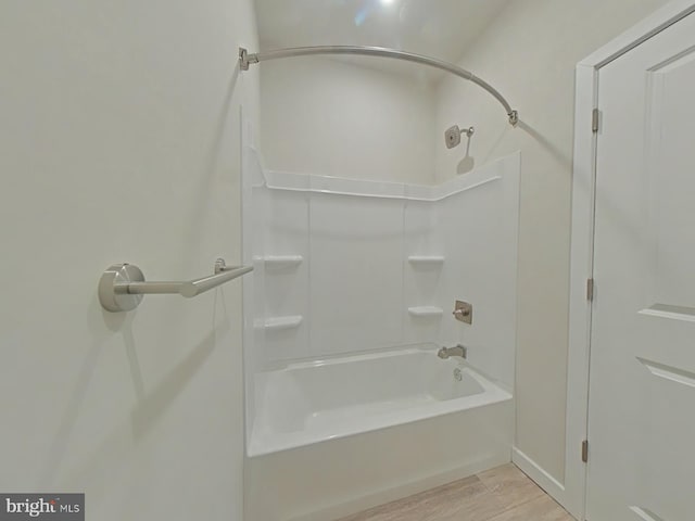 bathroom with shower / bathing tub combination and wood-type flooring