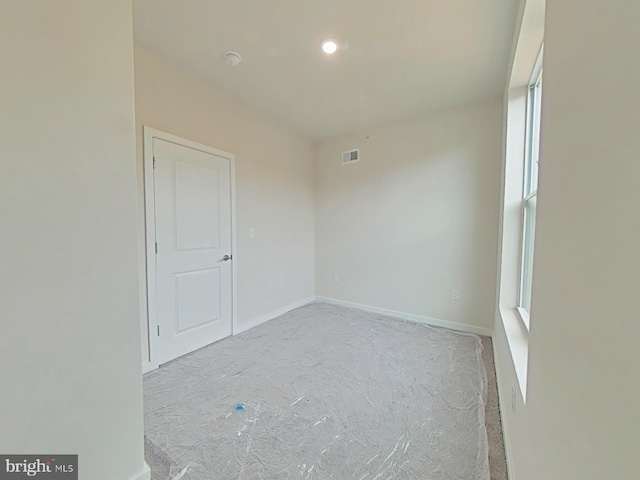 unfurnished room with light colored carpet