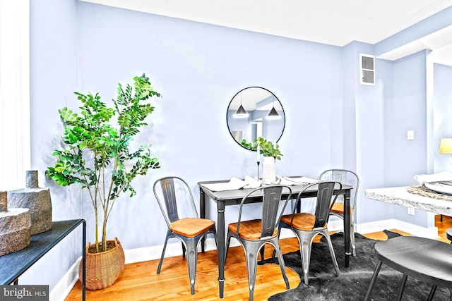 dining area with hardwood / wood-style flooring