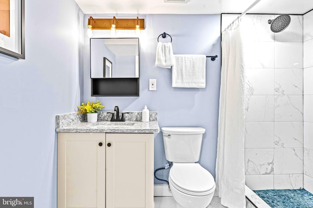 bathroom with toilet, vanity, and a shower with shower curtain