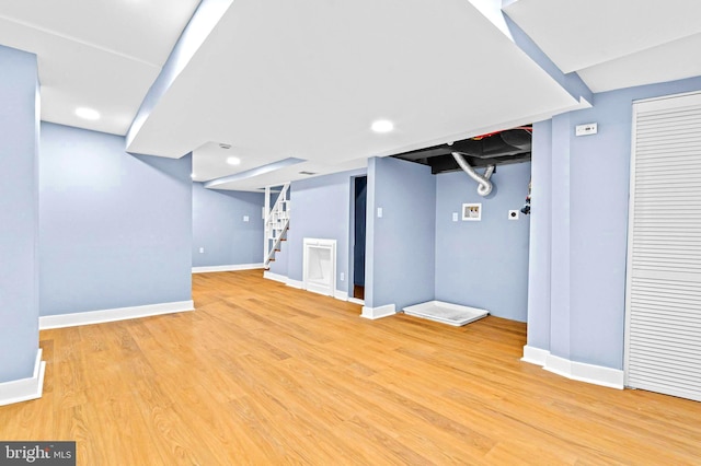 basement with hardwood / wood-style flooring