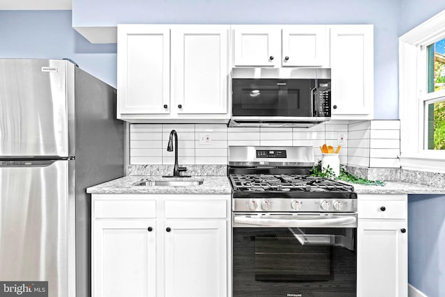 kitchen featuring sink, white cabinets, and appliances with stainless steel finishes