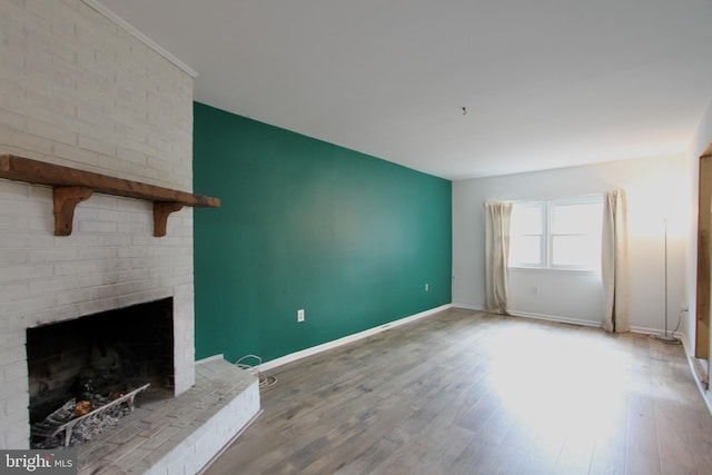 unfurnished living room with wood-type flooring and a fireplace