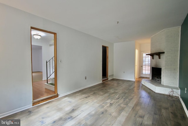 unfurnished living room featuring a fireplace and wood-type flooring