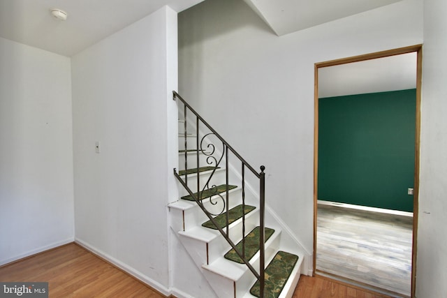 staircase with wood-type flooring