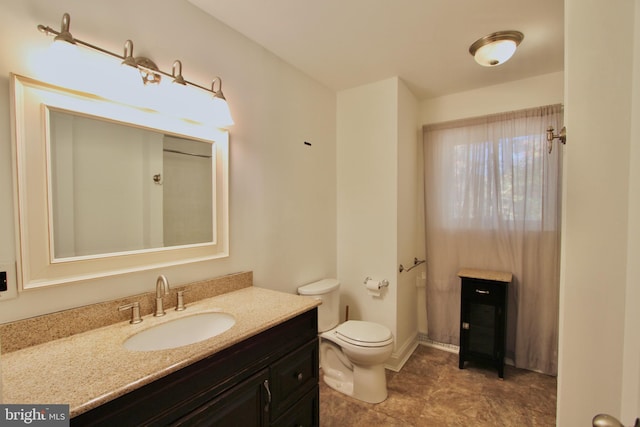 bathroom featuring toilet and vanity