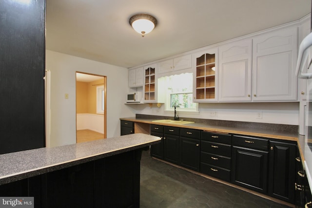 kitchen featuring white cabinetry and sink