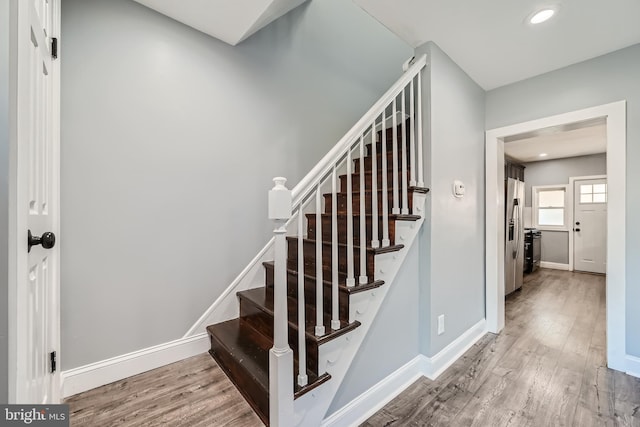 stairway featuring wood-type flooring