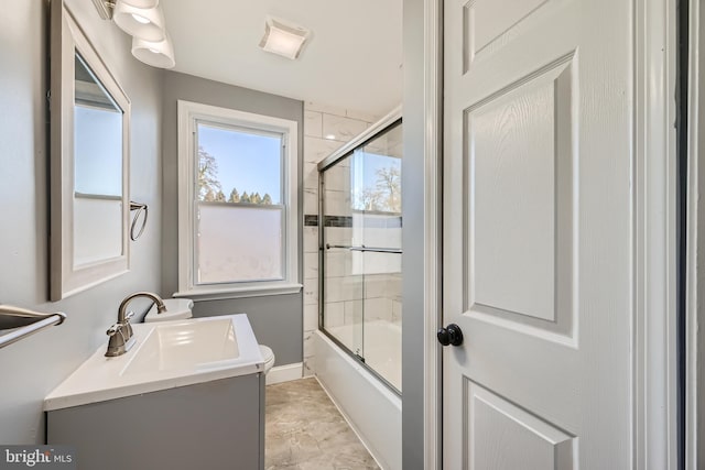 full bathroom with vanity, combined bath / shower with glass door, and toilet