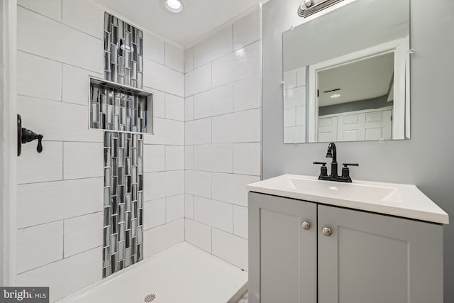 bathroom featuring vanity and a tile shower