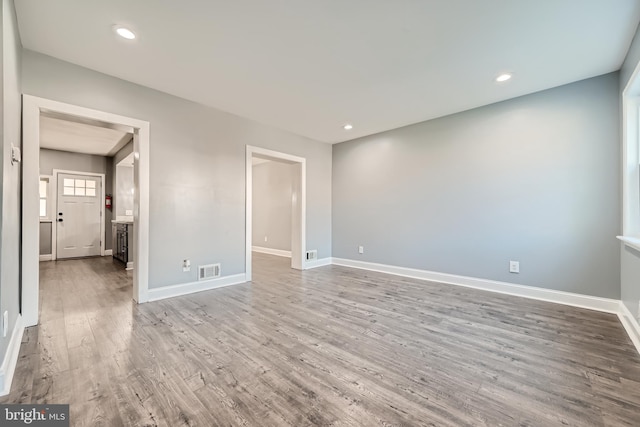 unfurnished room with hardwood / wood-style floors