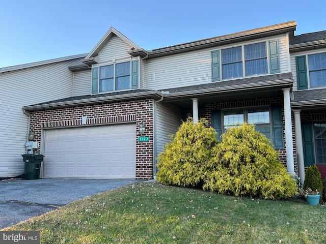 view of front of house featuring a garage and a front yard