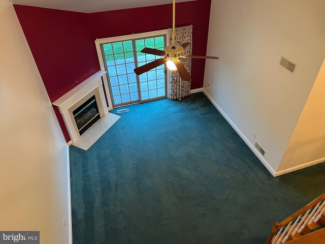 unfurnished living room with carpet and ceiling fan