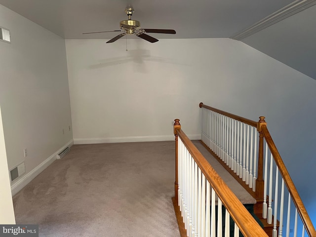 hallway with lofted ceiling and carpet