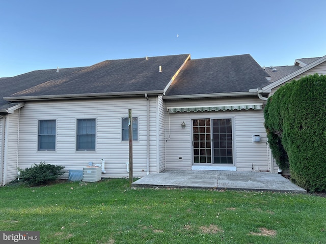 back of property with cooling unit, a yard, and a patio area