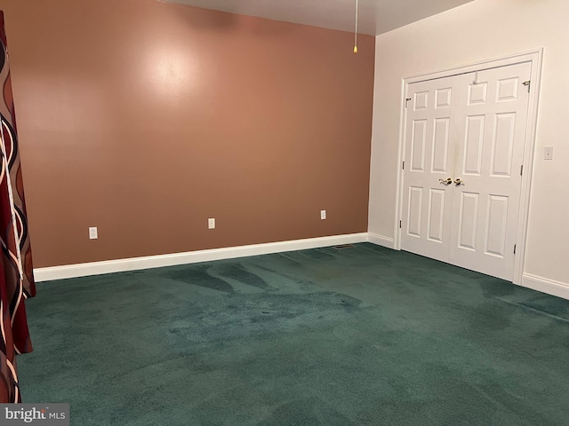 unfurnished bedroom with a closet and dark carpet