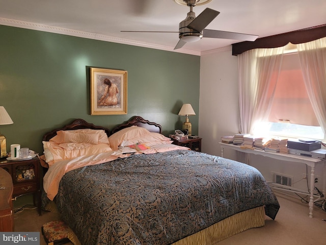 carpeted bedroom featuring ceiling fan and ornamental molding