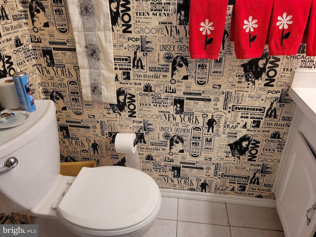 bathroom with tile patterned flooring, vanity, and toilet