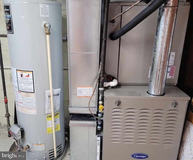 utility room with heating unit and water heater