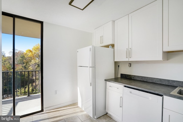 kitchen featuring white cabinets, white appliances, and plenty of natural light