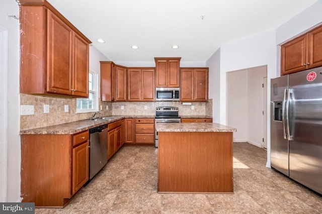 kitchen featuring sink, tasteful backsplash, a kitchen island, light stone counters, and stainless steel appliances